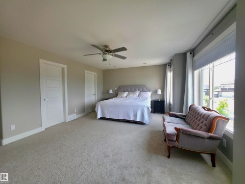 Spacious room featuring neutral carpeting and a ceiling fan - 1 Hemlock Close, Fort Saskatchewan, AB 