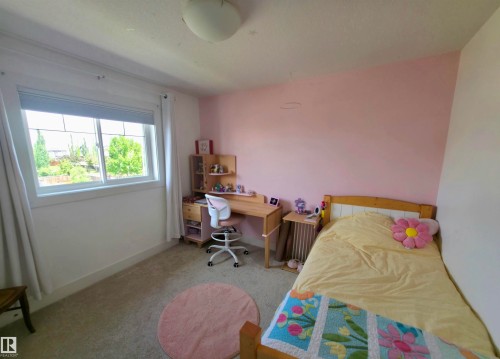 Carpeted room featuring a white-framed window with blinds, a built-in ceiling light, and light-colored walls - 1 Hemlock Close, Fort Saskatchewan, AB 
