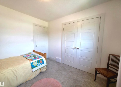 Interior room featuring light gray carpeting, white walls, and bright white trim - 1 Hemlock Close, Fort Saskatchewan, AB 