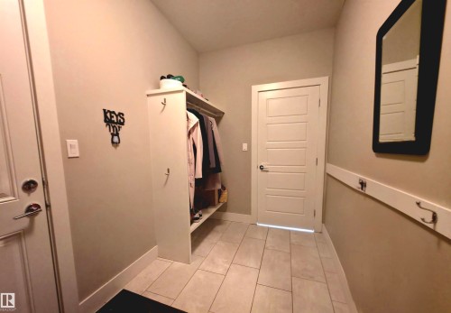 Entryway featuring light-toned tile flooring and painted walls - 1 Hemlock Close, Fort Saskatchewan, AB 