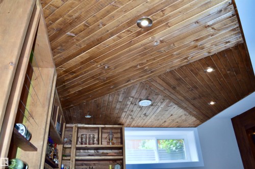 Angled wood-finish plank ceiling with integrated recessed lighting - 1 Hemlock Close, Fort Saskatchewan, AB 