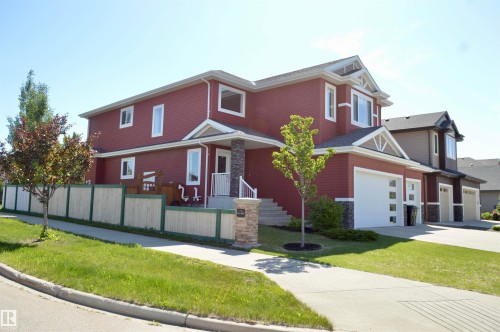 Two-story residence featuring red siding and white trim - 1 Hemlock Close, Fort Saskatchewan, AB 