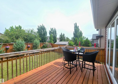 Spacious wood deck with railing overlooking a fenced yard - 1 Hemlock Close, Fort Saskatchewan, AB 