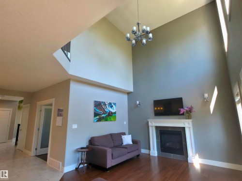 Living area with vaulted ceilings and wood-finish flooring - 1 Hemlock Close, Fort Saskatchewan, AB 