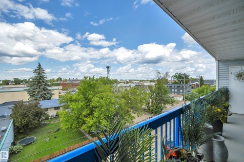 Balcony with blue railings and horizontal siding exterior - 305 5212 48 Avenue, Wetaskiwin, AB 