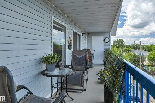 Private balcony featuring horizontal plank siding - 305 5212 48 Avenue, Wetaskiwin, AB 