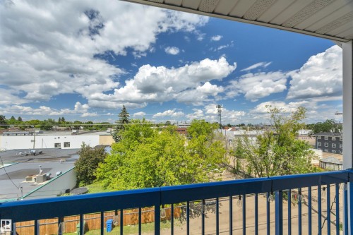 Outdoor balcony featuring a blue metal railing, offering expansive open-sky views - 305 5212 48 Avenue, Wetaskiwin, AB 