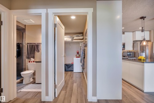 Hallway featuring wood-finish flooring - 305 5212 48 Avenue, Wetaskiwin, AB 