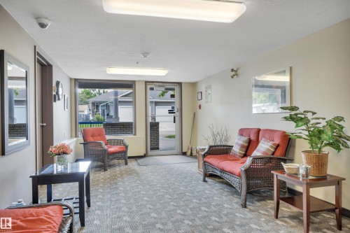 Interior common area featuring neutral wall tones and patterned carpeting - 305 5212 48 Avenue, Wetaskiwin, AB 