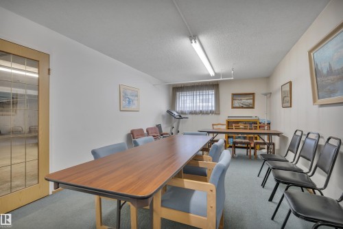 Spacious room with light-colored walls and carpet flooring - 305 5212 48 Avenue, Wetaskiwin, AB 