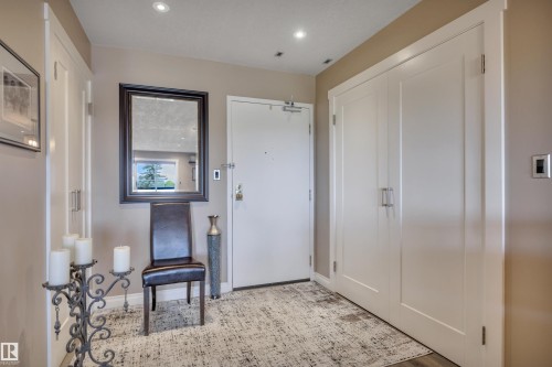 Inviting foyer with recessed lighting, light neutral wall tones, and a large front entry door - 305 5212 48 Avenue, Wetaskiwin, AB 