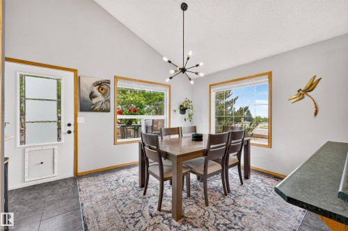 Dining area featuring vaulted ceilings and a contemporary sputnik chandelier - 1 Primrose Boulevard, Sherwood Park, AB 