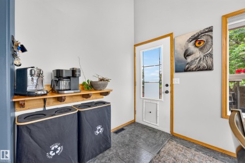 Entryway featuring a white door with a window insert, wood trim, and durable flooring - 1 Primrose Boulevard, Sherwood Park, AB 