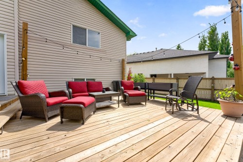 Spacious wooden deck featuring string lights and direct access to the home - 1 Primrose Boulevard, Sherwood Park, AB 