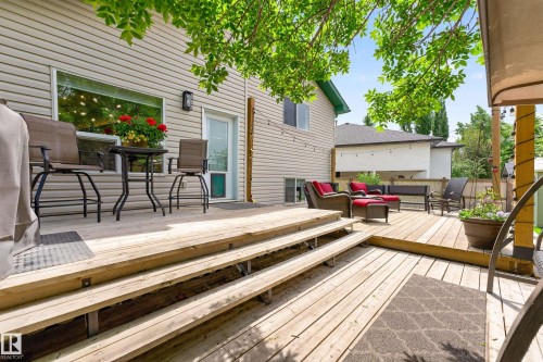 Multi-level wood deck featuring a primary elevated platform, a lower-level extension, and broad steps - 1 Primrose Boulevard, Sherwood Park, AB 