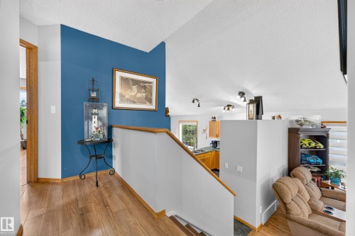 Open-concept living space with wood-finish flooring and a vaulted ceiling - 1 Primrose Boulevard, Sherwood Park, AB 