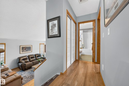 Wood-finish flooring throughout the hallway and living area - 1 Primrose Boulevard, Sherwood Park, AB 