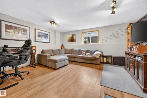 Recreational room with wood-finish flooring, light gray walls, and recessed lighting - 1 Primrose Boulevard, Sherwood Park, AB 