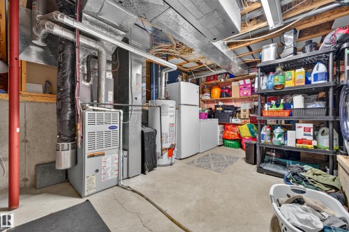 Utility room with concrete flooring, exposed ceiling joists, and overhead fluorescent lighting - 1 Primrose Boulevard, Sherwood Park, AB 