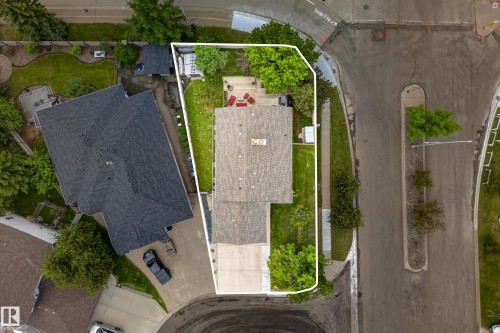 Expansive lot featuring a large residential structure with a shingle roof, a generously sized concrete driveway, and established green landscaping - 1 Primrose Boulevard, Sherwood Park, AB 