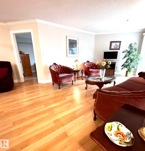 Light wood-finish flooring extending throughout the living area - 330 13111 140 Avenue, Edmonton, AB 