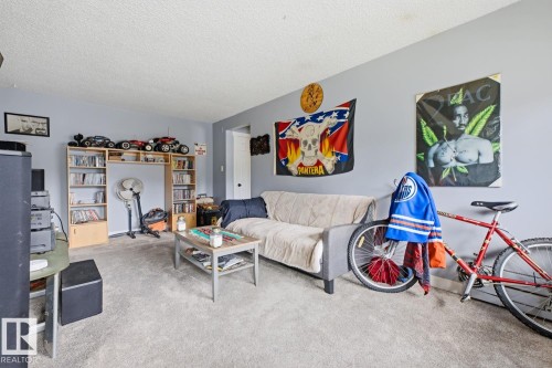 Carpeted room with light grey wall paint - 15 10164 150 Street, Edmonton, AB 