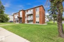 Brick-clad building with multiple private balconies, featuring a covered main entrance - 15 10164 150 Street, Edmonton, AB 