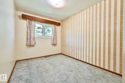 Room featuring a double-pane window, wood trim, wall-to-wall carpeting, and a ceiling-mounted light fixture - 