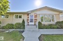 Spacious garage with multiple windows for natural light, exposed wood-paneled walls, and built-in workbench areas - 12919 86 Street, Edmonton, AB 