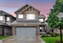 Modern two-story residence featuring a multi-textured facade with stone, horizontal siding, and shake accents - 1603 158 Street, Edmonton, AB 