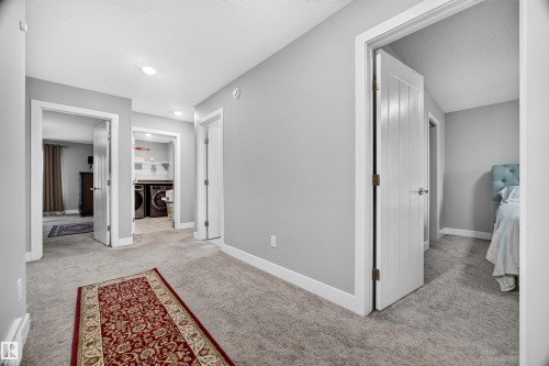 Central hallway featuring light gray walls, recessed lighting, and soft gray carpeting - 1603 158 Street, Edmonton, AB 