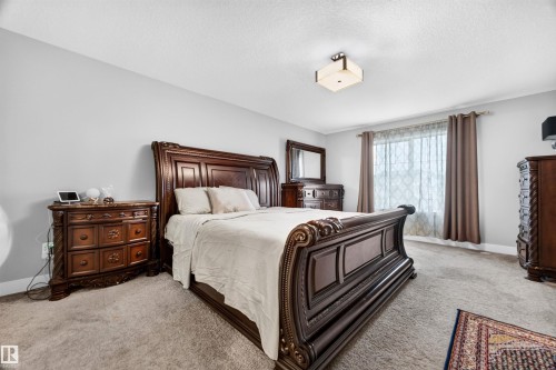 Spacious room featuring light gray wall paint and carpeted flooring - 1603 158 Street, Edmonton, AB 