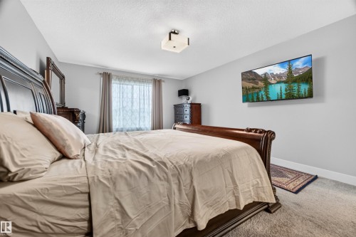 Bedroom featuring light gray walls and a window with neutral drapes - 1603 158 Street, Edmonton, AB 