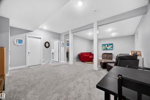 Spacious finished room featuring light gray walls, recessed lighting, and carpeted flooring - 1603 158 Street, Edmonton, AB 