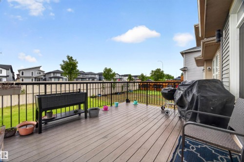 Spacious outdoor deck featuring wood-finish flooring and black metal railings - 1603 158 Street, Edmonton, AB 