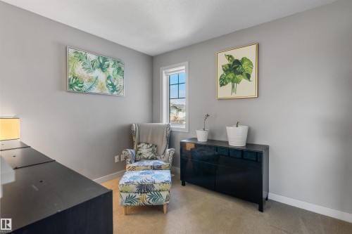 Carpeted room with light gray walls, a white window frame, and white baseboards - 1651 Hammond Crescent, Edmonton, AB 
