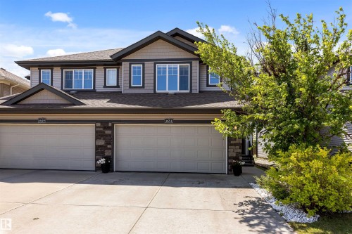 Two-story residence featuring a combination of horizontal siding and shingle accents - 1651 Hammond Crescent, Edmonton, AB 