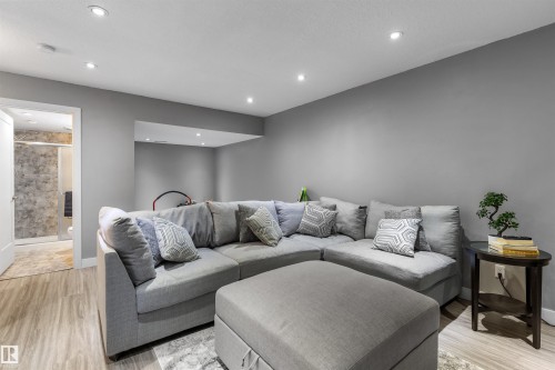 Recessed lighting illuminates this room featuring light wood-finish flooring and neutral gray walls - 1651 Hammond Crescent, Edmonton, AB 