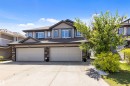 Contemporary residence featuring a dual-tone siding exterior, stone accents, and multiple dormer windows - 1651 Hammond Crescent, Edmonton, AB 