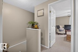 Hallway with neutral painted walls and white trim - 