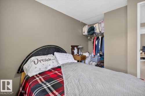 Recessed closet with hanging rod and upper shelf storage - 27 Walden Park, St. Albert, AB 