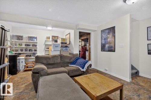 Finished lower level featuring neutral wall tones, recessed lighting, and tile flooring - 27 Walden Park, St. Albert, AB 