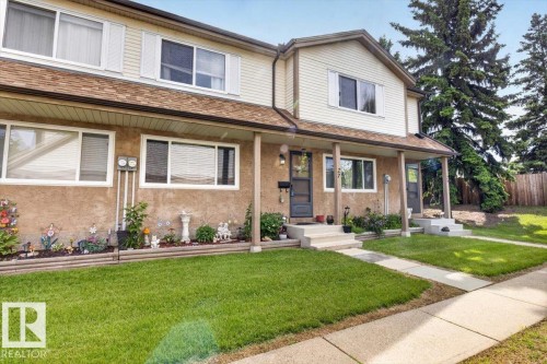Two-story residence featuring a brown shingle roof and beige siding - 27 Walden Park, St. Albert, AB 