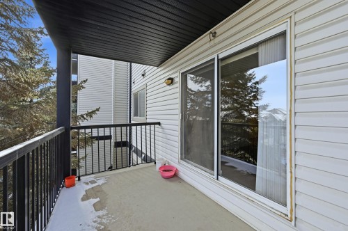 Private exterior balcony featuring a concrete floor, black metal railings, and a black soffit - 314 2430 Guardian Road, Edmonton, AB 