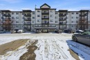 Multi-story building featuring a light-colored facade with dark trim accents - 314 2430 Guardian Road, Edmonton, AB 