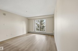 Bright room with light-toned wood-finish flooring - 