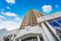 Multi-story building featuring a beige facade and numerous balconies - 