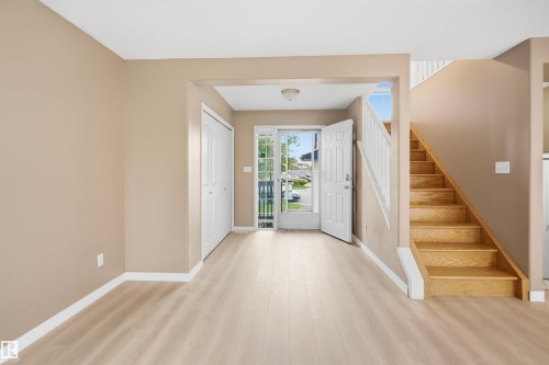 Foyer with light wood-finish flooring, neutral paint palette, and white trim - 2610 33A Street, Edmonton, AB - Indoor Photo Showing Other Room