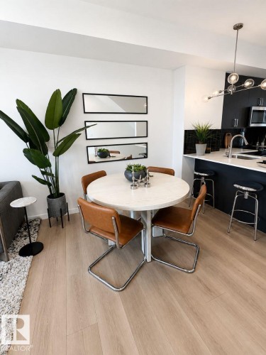 Open-concept living space featuring light wood-finish flooring throughout - 311 32 Street, Edmonton, AB 