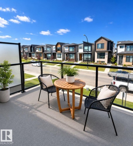 Outdoor balcony with textured grey flooring and glass panel railing - 311 32 Street, Edmonton, AB 